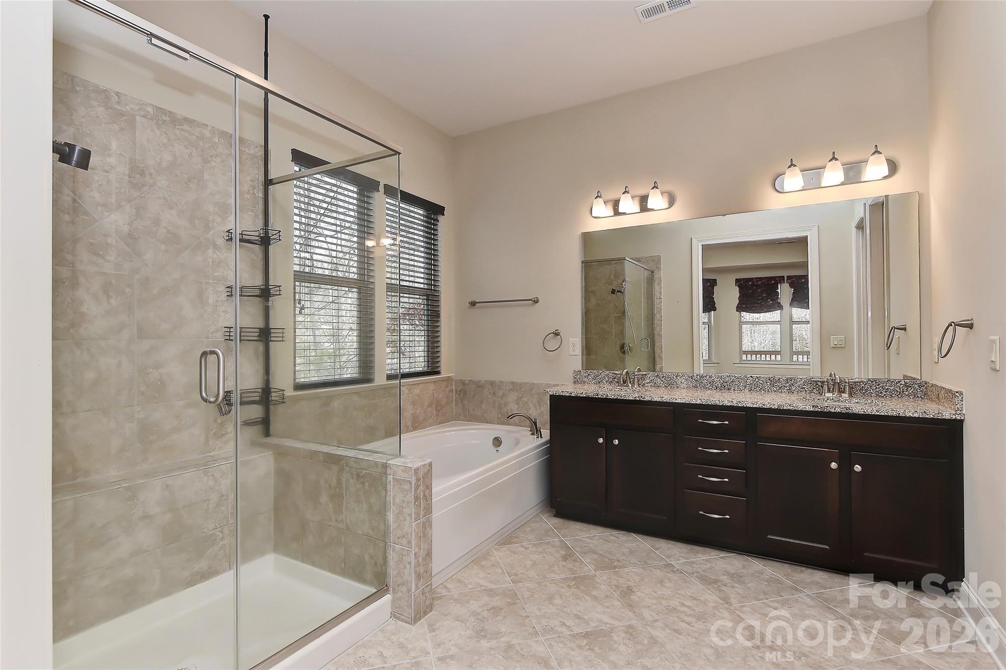 2287 Sweet Clover Way Denver, NC 28037 - Photo 24 of 44 a spacious bathroom with a tub sink shower and mirror