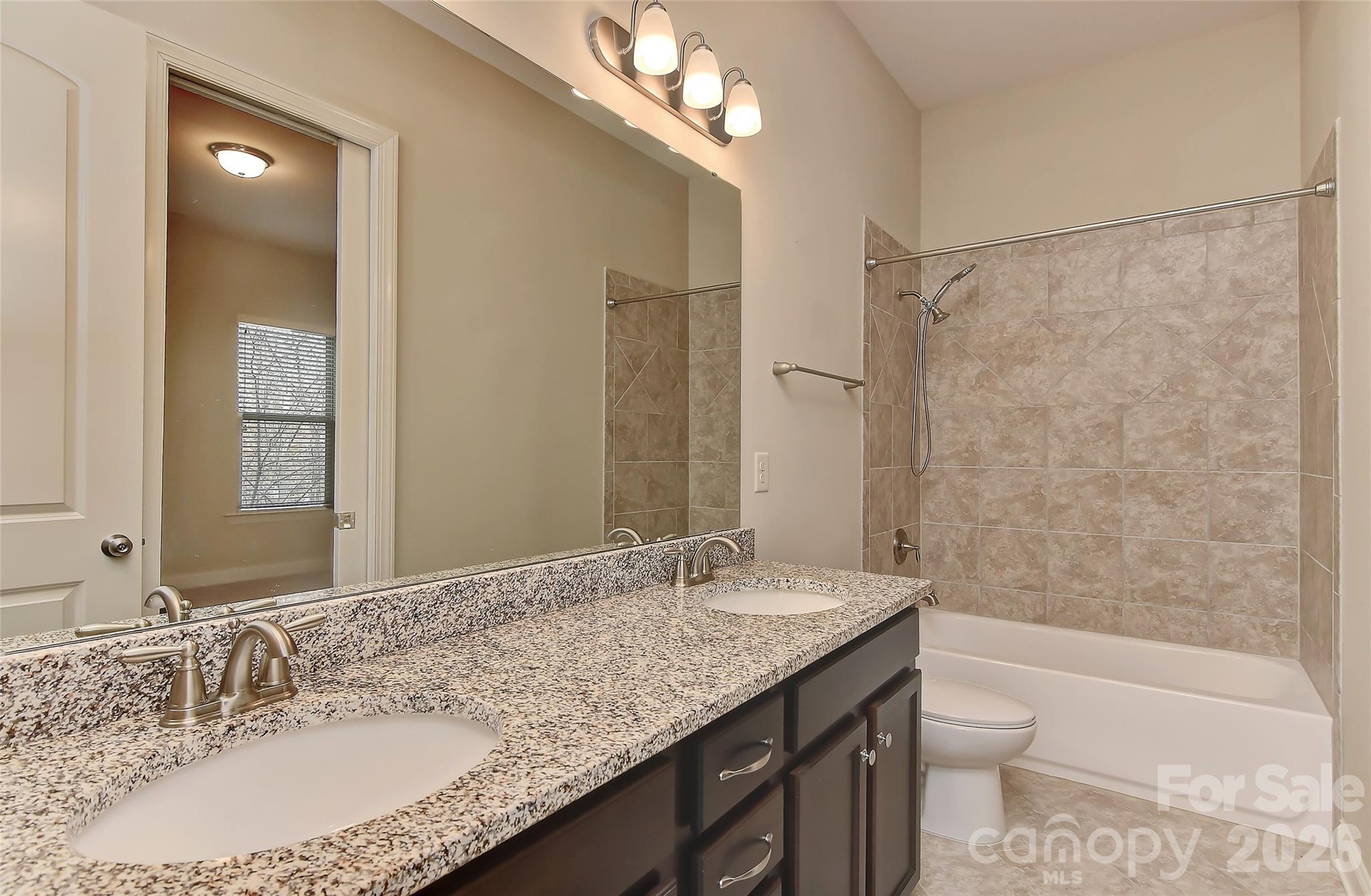 2287 Sweet Clover Way Denver, NC 28037 - Photo 28 of 44 a bathroom with a granite countertop sink a toilet a mirror and shower