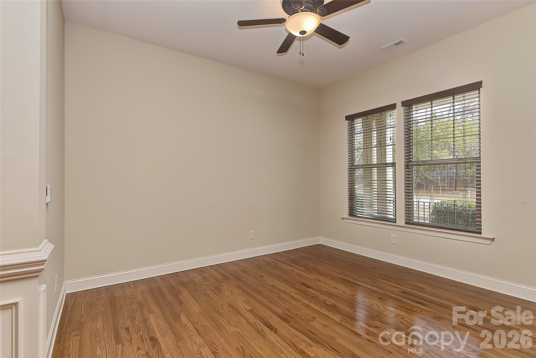 2287 Sweet Clover Way Denver, NC 28037 - Photo 9 of 44 a view of an empty room with wooden floor and a window