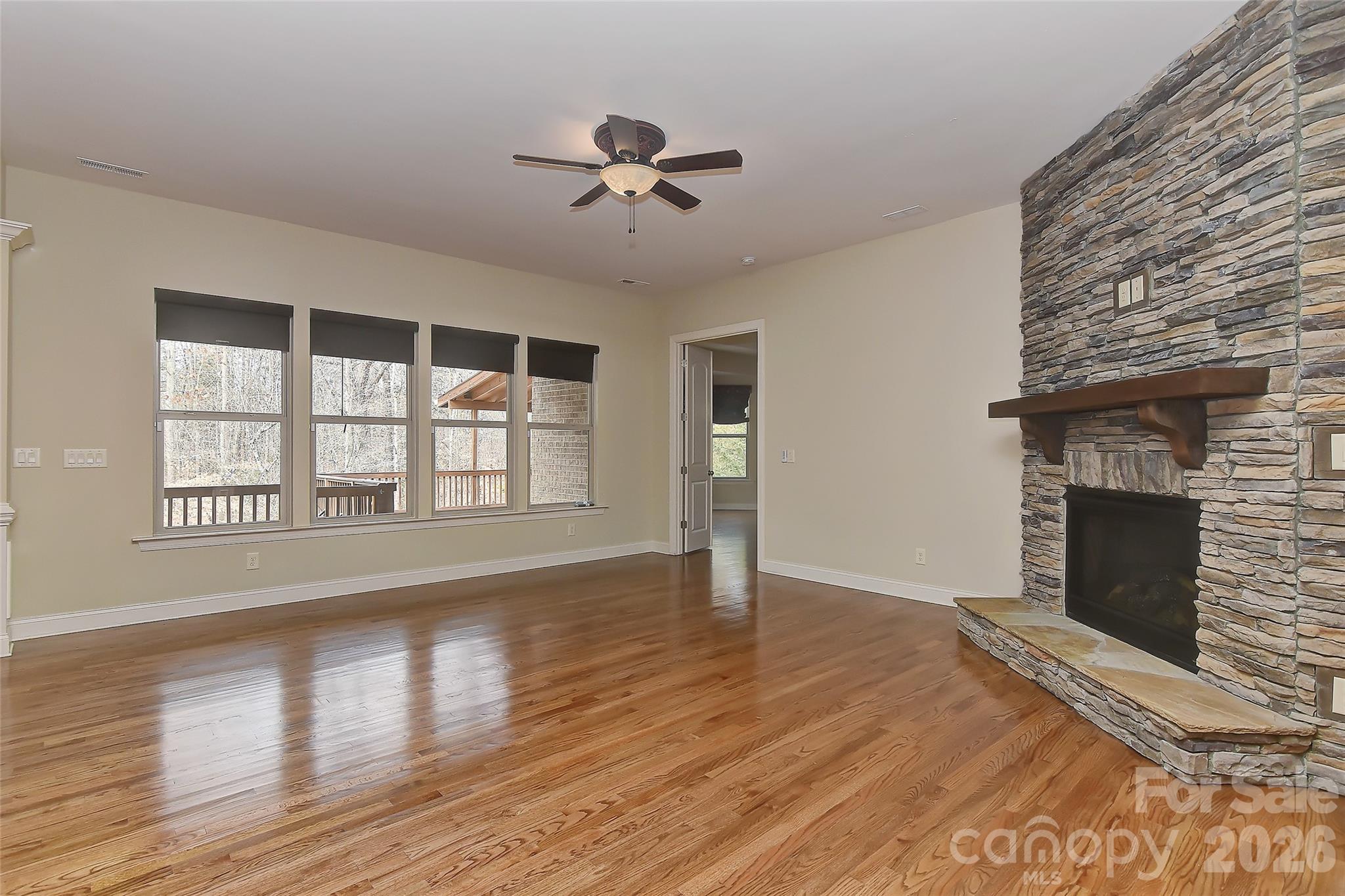 2287 Sweet Clover Way Denver, NC 28037 - Photo 10 of 44 a view of an empty room with wooden floor fireplace and a window