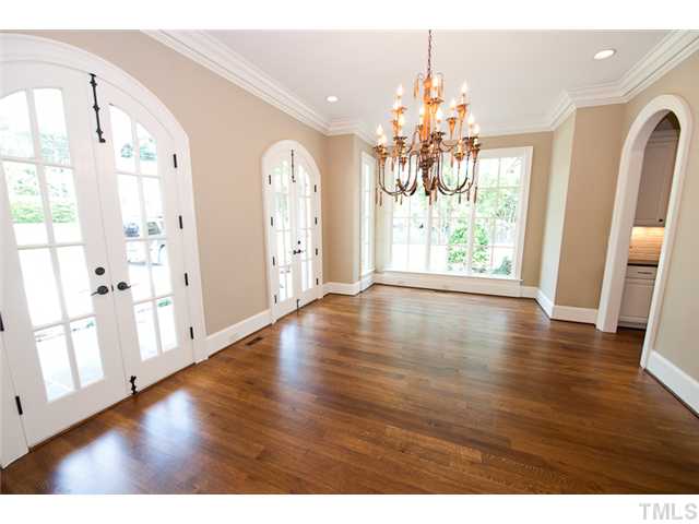 2506 Anderson Drive Raleigh, NC 27608 - Photo 3 of 12 a view of an empty room with wooden floor and a window