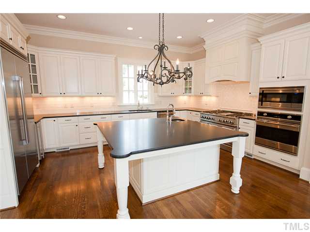 2506 Anderson Drive Raleigh, NC 27608 - Photo 5 of 12 a kitchen with a sink cabinets and wooden floor