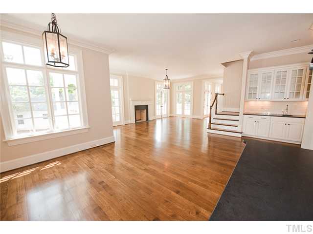 2506 Anderson Drive Raleigh, NC 27608 - Photo 6 of 12 a view of an empty room with wooden floor and a window