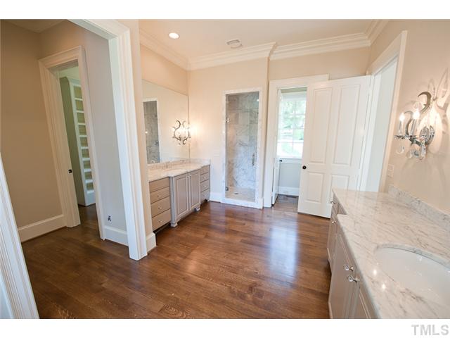 2506 Anderson Drive Raleigh, NC 27608 - Photo 8 of 12 a view of a hallway with wooden floor and cabinet