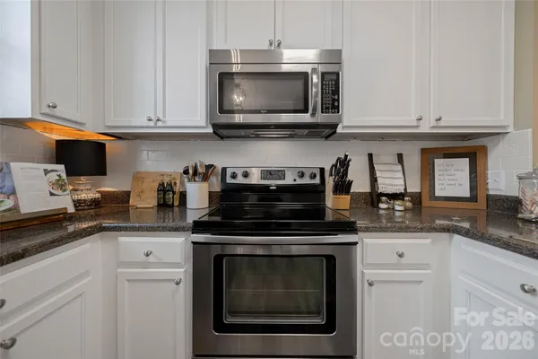 a kitchen with cabinets stainless steel appliances and a sink