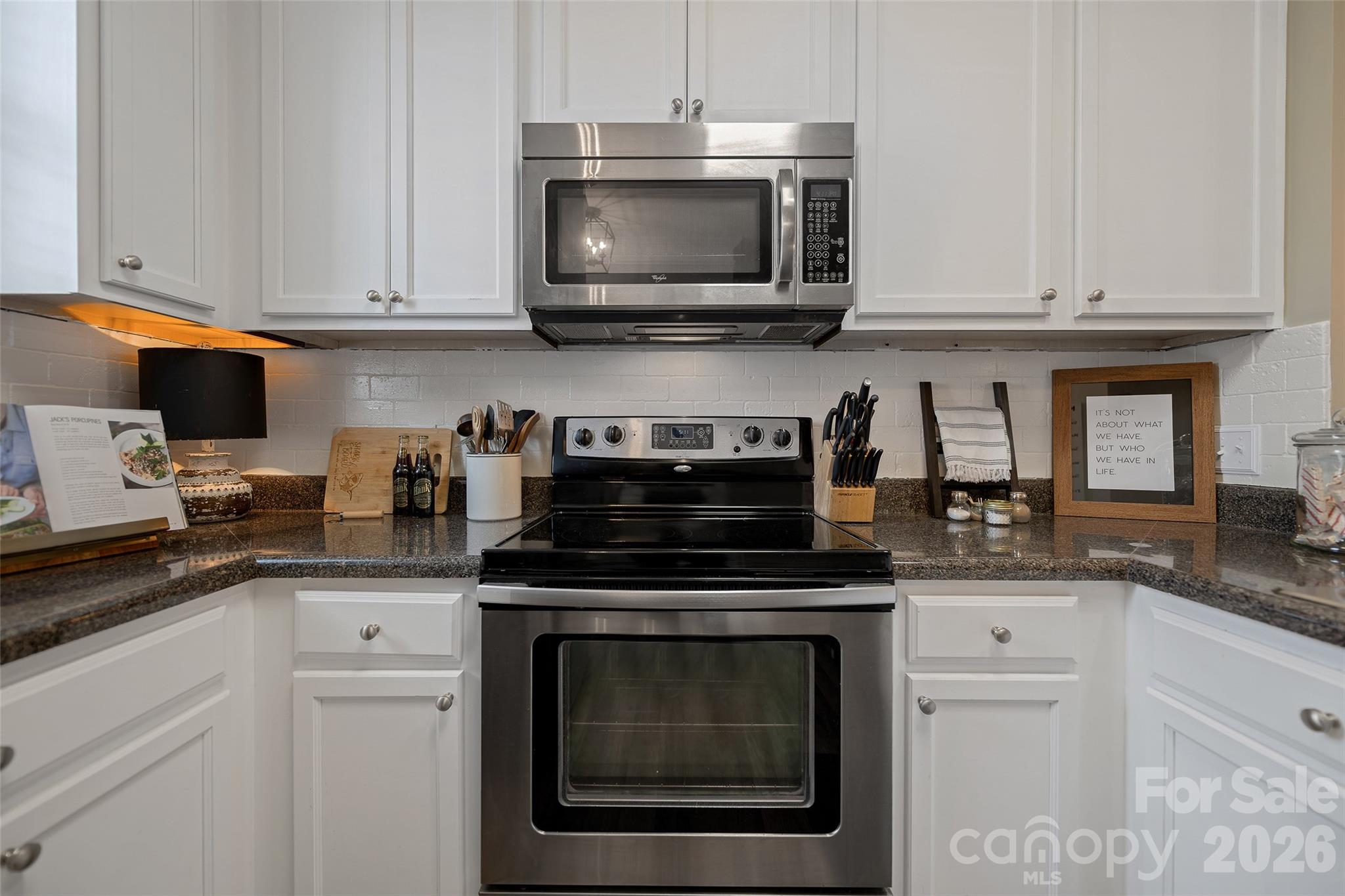 1213 Assembly Street Belmont, NC 28012 - Photo 11 of 32 a kitchen with cabinets stainless steel appliances and a sink