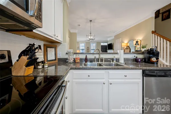 a kitchen with sink and cabinets