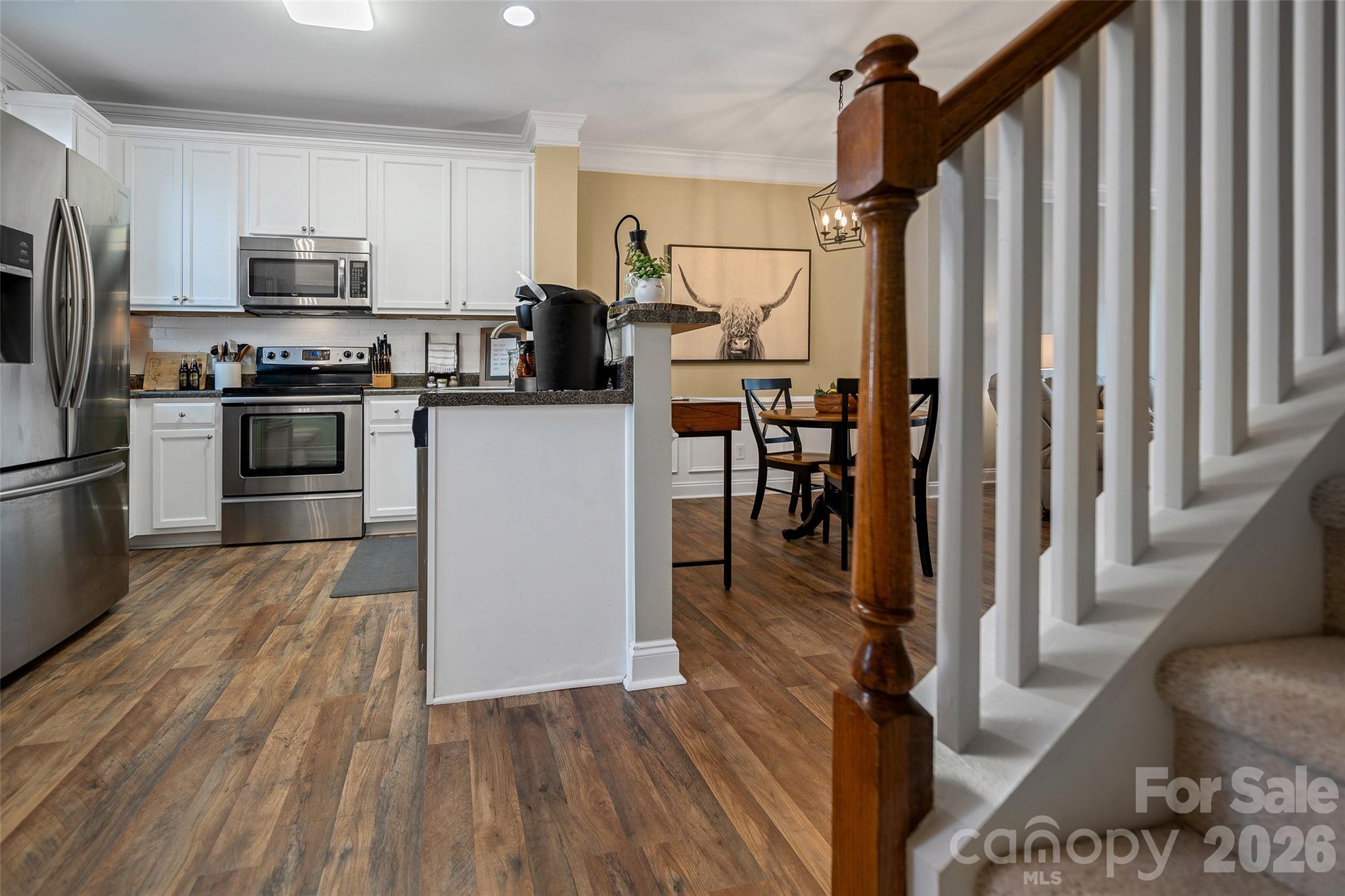 1213 Assembly Street Belmont, NC 28012 - Photo 14 of 32 a kitchen with granite countertop a refrigerator stove and wooden floor
