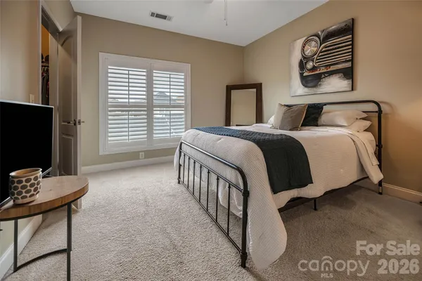 a bedroom with a bed chair and a window