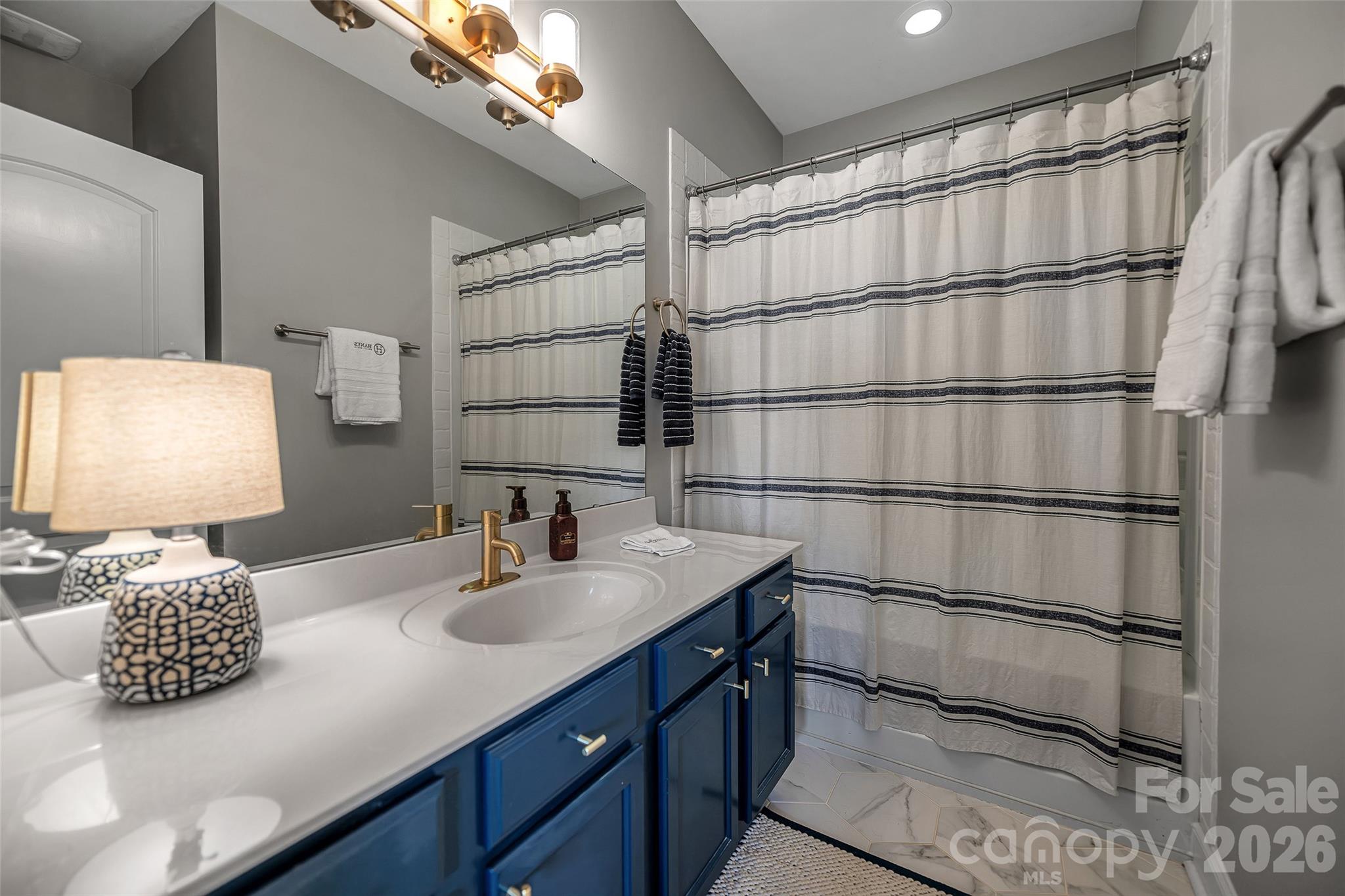 1213 Assembly Street Belmont, NC 28012 - Photo 17 of 32 a bathroom with a sink and a mirror