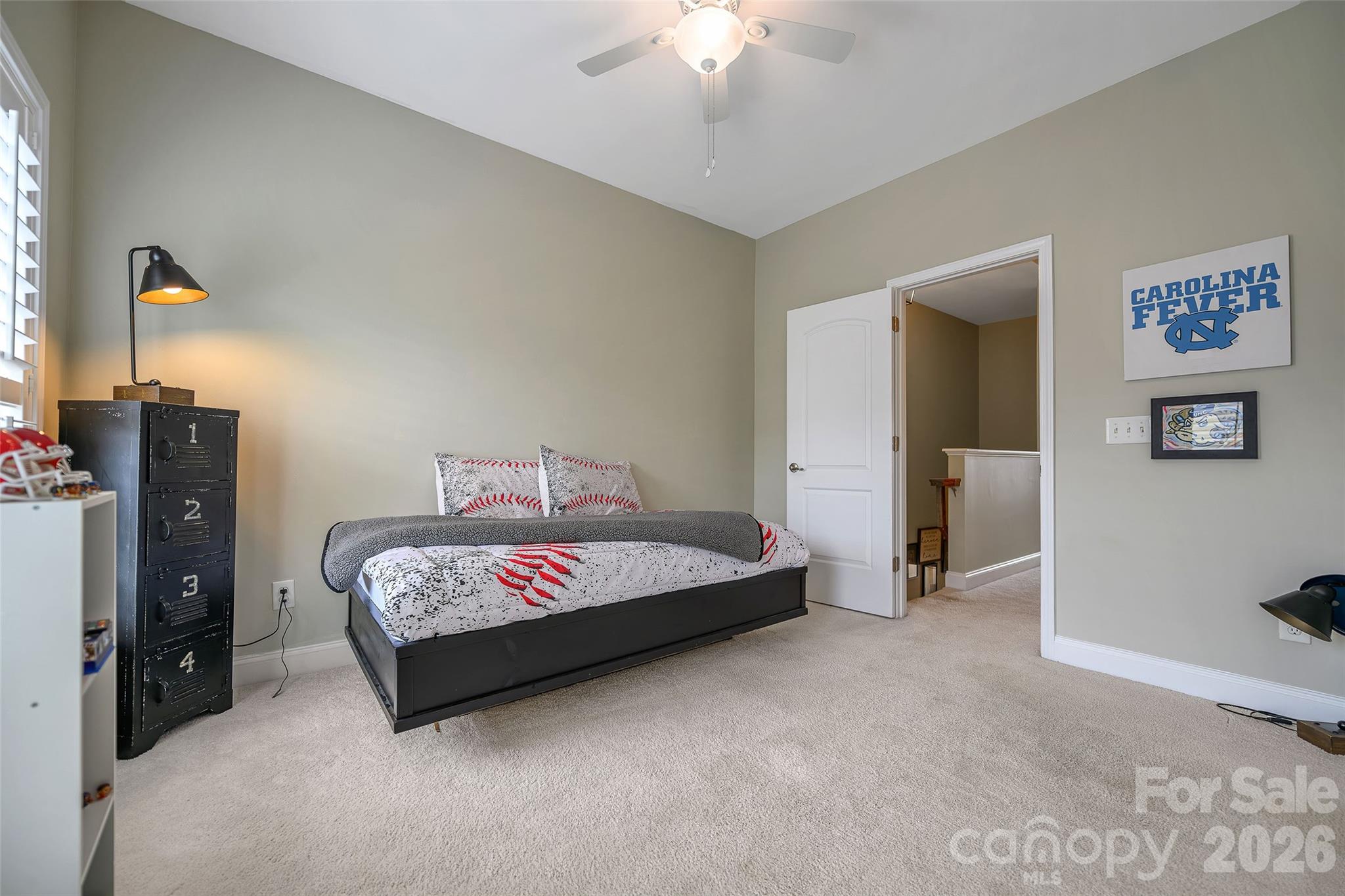 1213 Assembly Street Belmont, NC 28012 - Photo 19 of 32 a spacious bedroom with a bed and a chandelier