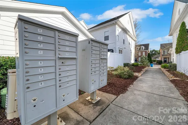 a view of a house with a space and a wooden bench