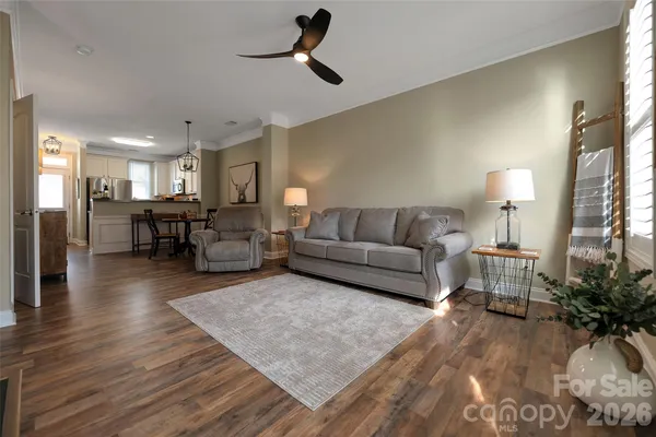 a living room with furniture and a wooden floor