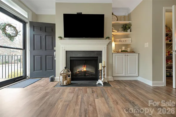a living room with a fireplace and a flat screen tv
