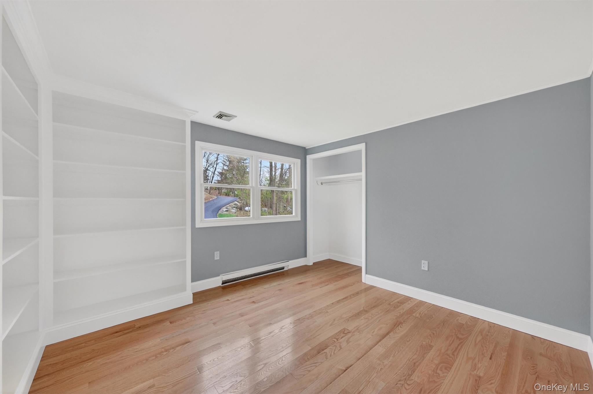 69 Hy Vue Terrace Cold Spring, NY 10516 - Photo 18 of 44 an empty room with wooden floor and windows