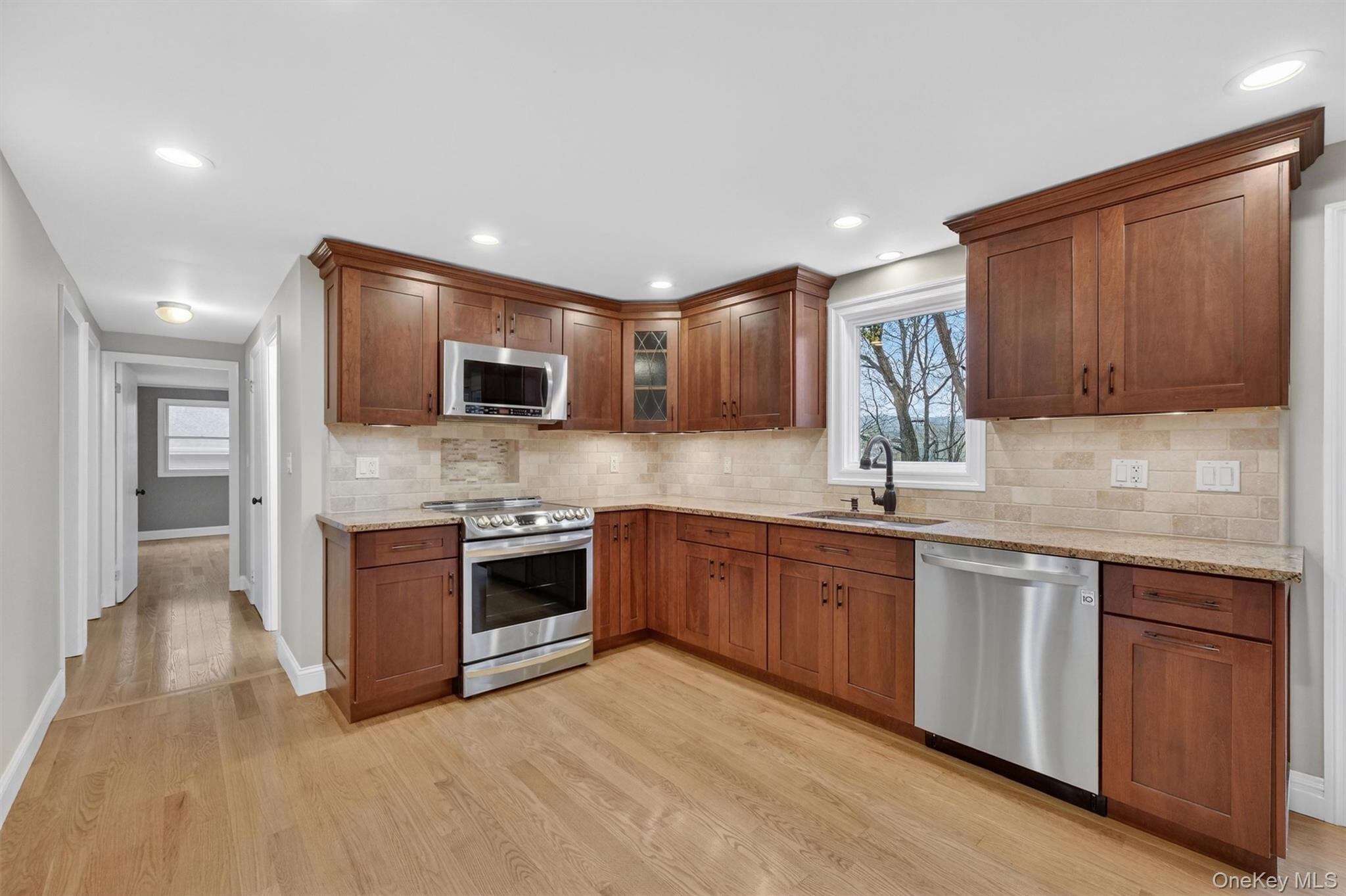 69 Hy Vue Terrace Cold Spring, NY 10516 - Photo 5 of 44 a kitchen with stainless steel appliances granite countertop wooden cabinets a stove top oven a sink and dishwasher