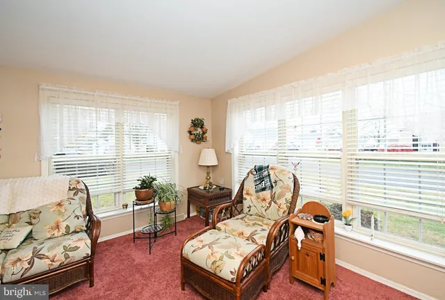 a bedroom with furniture and a large window
