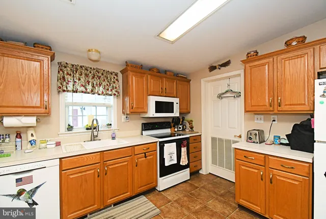 a kitchen with stainless steel appliances granite countertop a stove and a sink