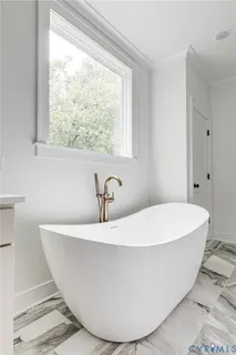 a white bath tub sitting in a bathroom
