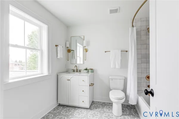 a bathroom with a granite countertop toilet a sink and a mirror