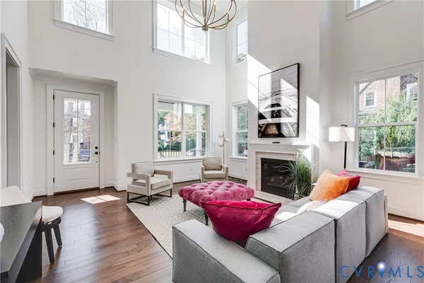 a living room with furniture a fireplace and windows