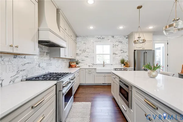 a kitchen with a sink stove and cabinets