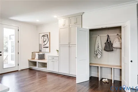 a view of empty room with wooden floor
