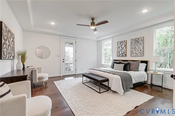 a spacious bedroom with a bed a couch and a window