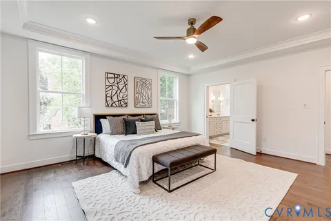 a bedroom with a large bed and a chandelier