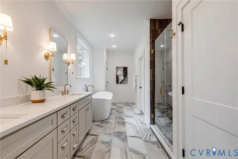 a spacious bathroom with a granite countertop sink a toilet a mirror and shower