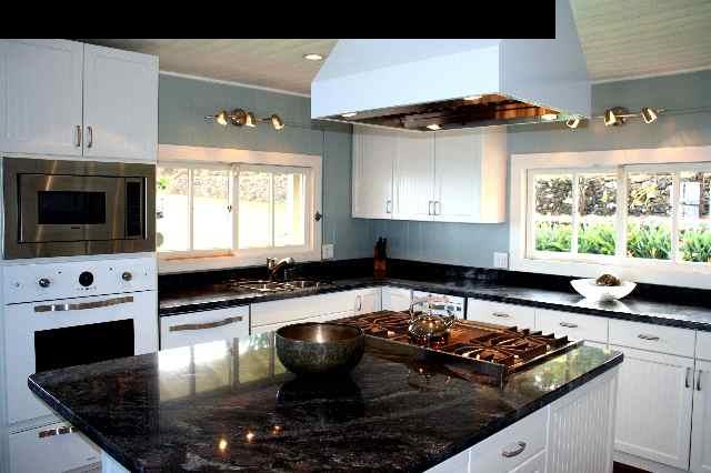 1070 Polipoli Road Kula, HI 96790 - Photo 17 of 20 a kitchen with a stove a microwave and cabinets