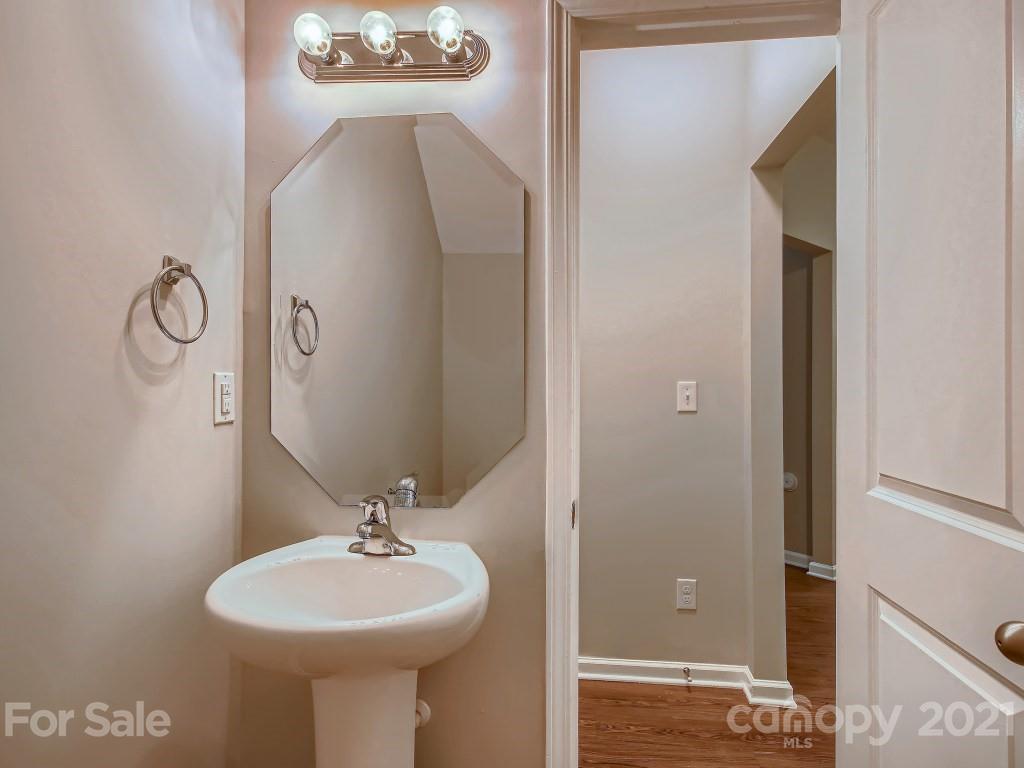 4040 Queensbridge Road Charlotte, NC 28213 - Photo 13 of 28 a bathroom with a sink and a mirror