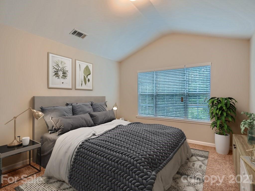4040 Queensbridge Road Charlotte, NC 28213 - Photo 14 of 28 a bedroom with a large bed and a potted plant