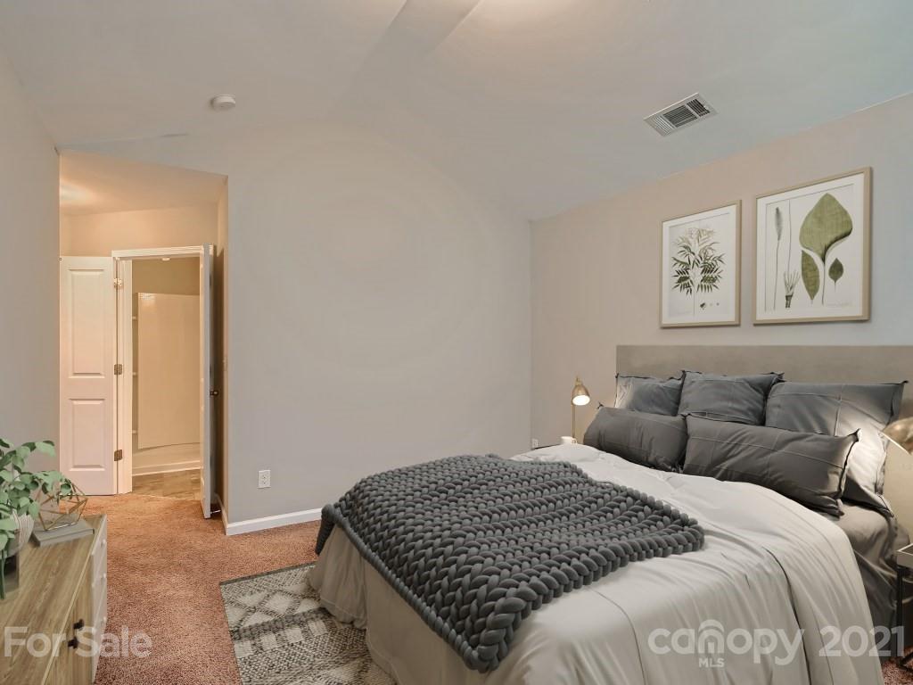 4040 Queensbridge Road Charlotte, NC 28213 - Photo 15 of 28 a bedroom with a bed and a painting on the wall