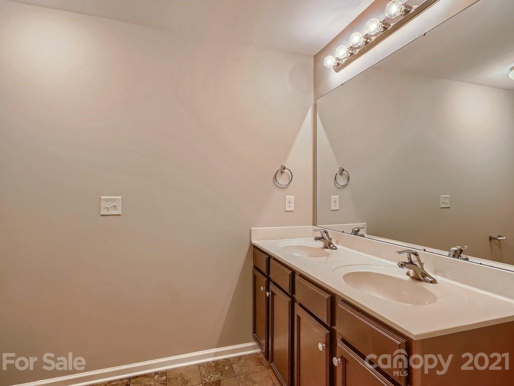 4040 Queensbridge Road Charlotte, NC 28213 - Photo 16 of 28 a bathroom with a sink and a mirror