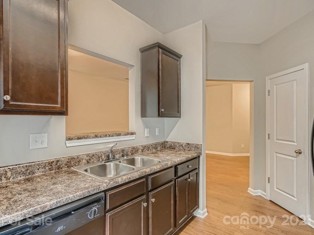 4040 Queensbridge Road Charlotte, NC 28213 - Photo 10 of 28 a bathroom with a granite countertop sink and a mirror