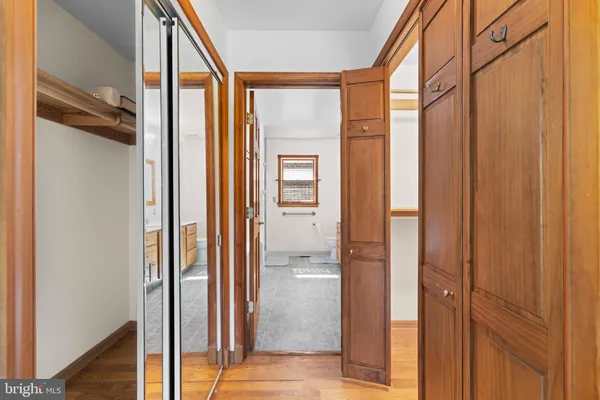 a bedroom with a large bed and a flat tv screen on dresser