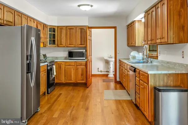 a kitchen with stainless steel appliances granite countertop a refrigerator a stove top oven a sink and dishwasher
