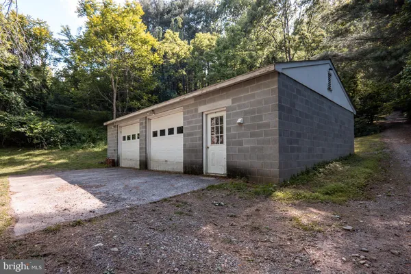 a view of green field with trees in the background
