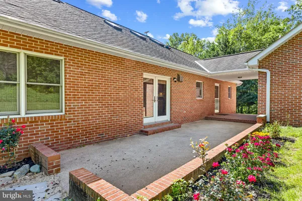 a backyard of a house with lots of green space and a fountain