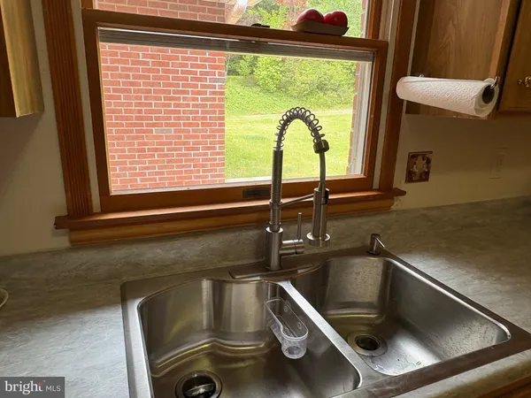 a bathroom with a sink a mirror and window