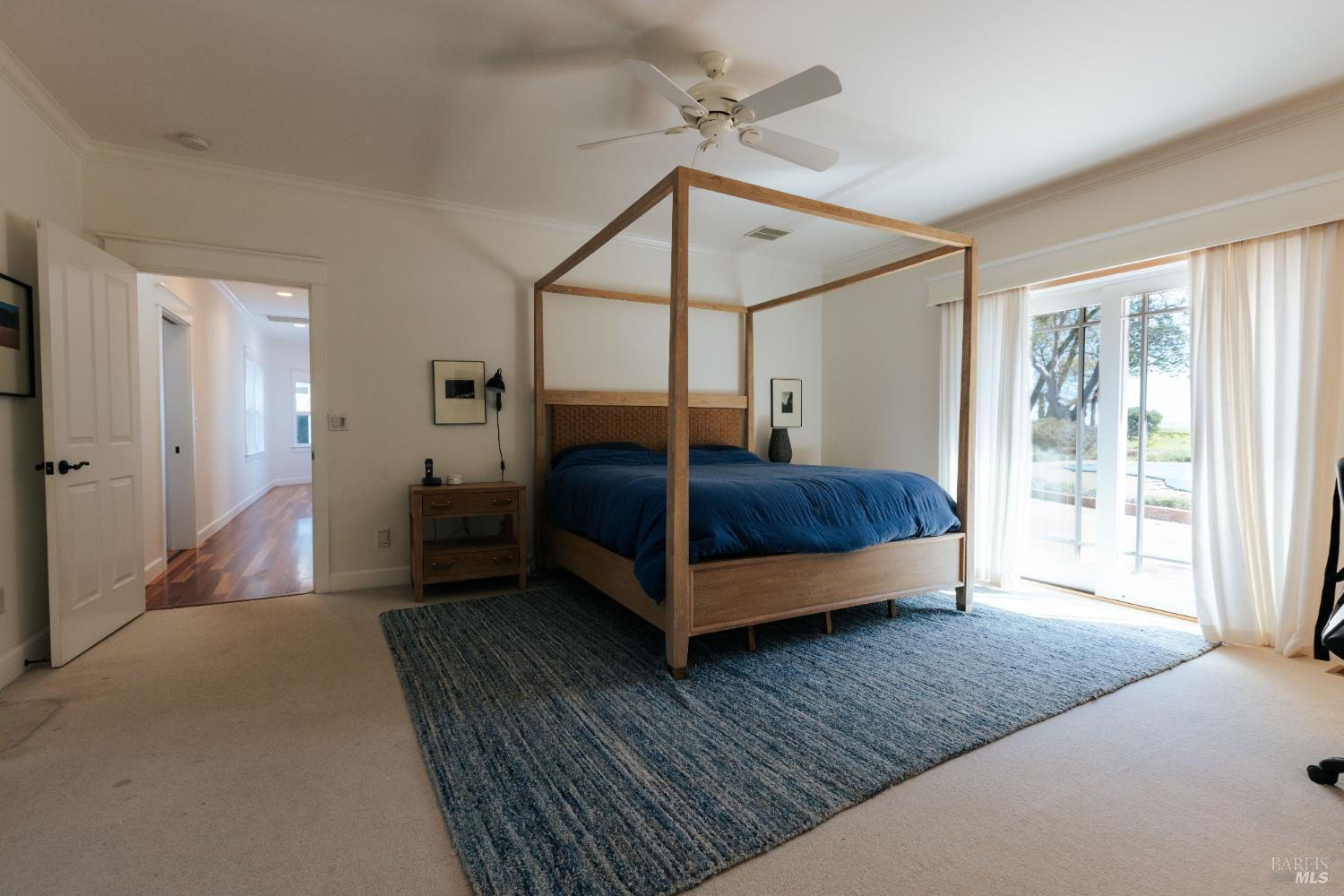 12801 Valley View Drive Ukiah, CA 95482 - Photo 10 of 22 a bedroom with a bed lamp and a large window