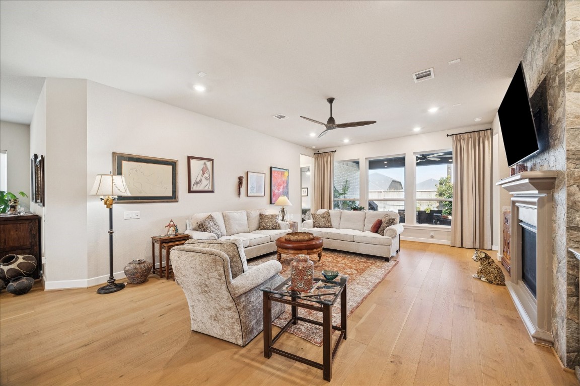 28722 Rising Moon Lane Fulshear, TX 77441 - Photo 14 of 30 a living room with fireplace furniture and a flat screen tv