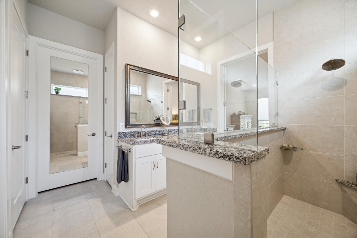 28722 Rising Moon Lane Fulshear, TX 77441 - Photo 20 of 30 a bathroom with a granite countertop sink and a mirror