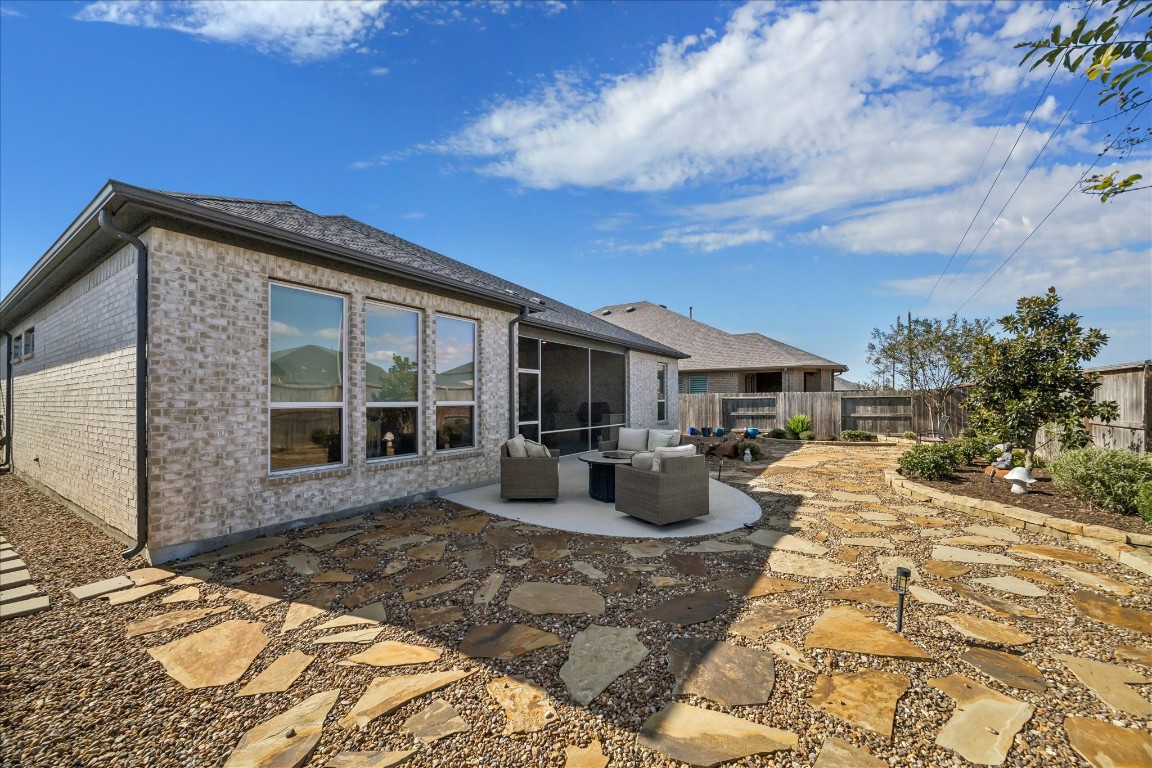 28722 Rising Moon Lane Fulshear, TX 77441 - Photo 29 of 30 a view of a house with backyard sitting area and porch