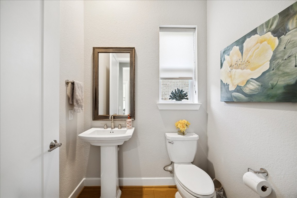 28722 Rising Moon Lane Fulshear, TX 77441 - Photo 4 of 30 a bathroom with a sink a toilet and a mirror