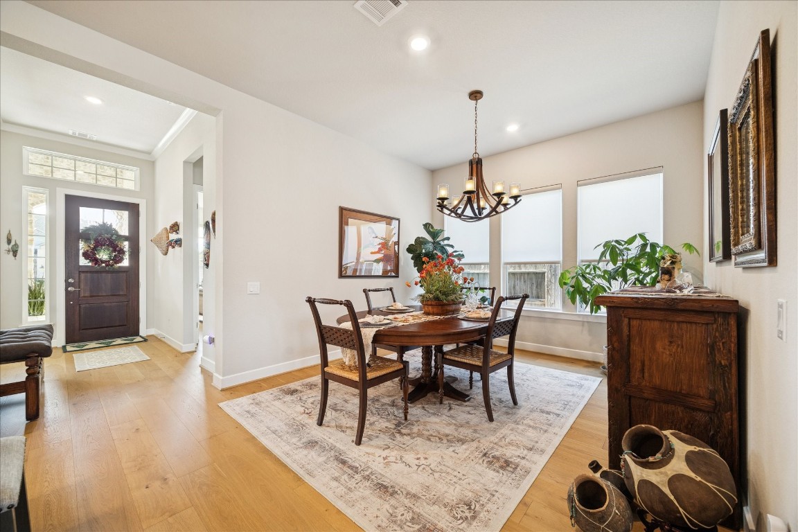 28722 Rising Moon Lane Fulshear, TX 77441 - Photo 6 of 30 a dining room with furniture potted plants and wooden floor