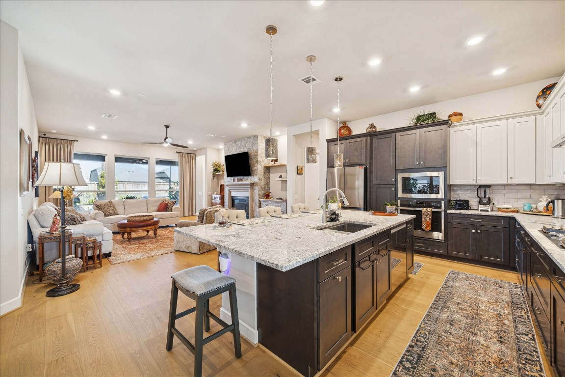28722 Rising Moon Lane Fulshear, TX 77441 - Photo 10 of 30 a large kitchen with kitchen island a sink table and chairs