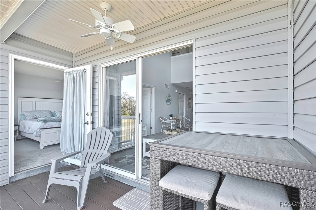 2855 North Rivers Edge Boulevard, Unit 213 Crystal River, FL 34429 - Photo 21 of 62 a bedroom with a bed and a chandelier