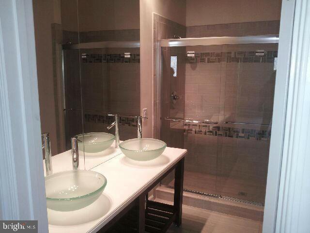 260 McCoys Ford Road Front Royal, VA 22630 - Photo 3 of 5 a bathroom with a granite countertop sink a mirror and shower
